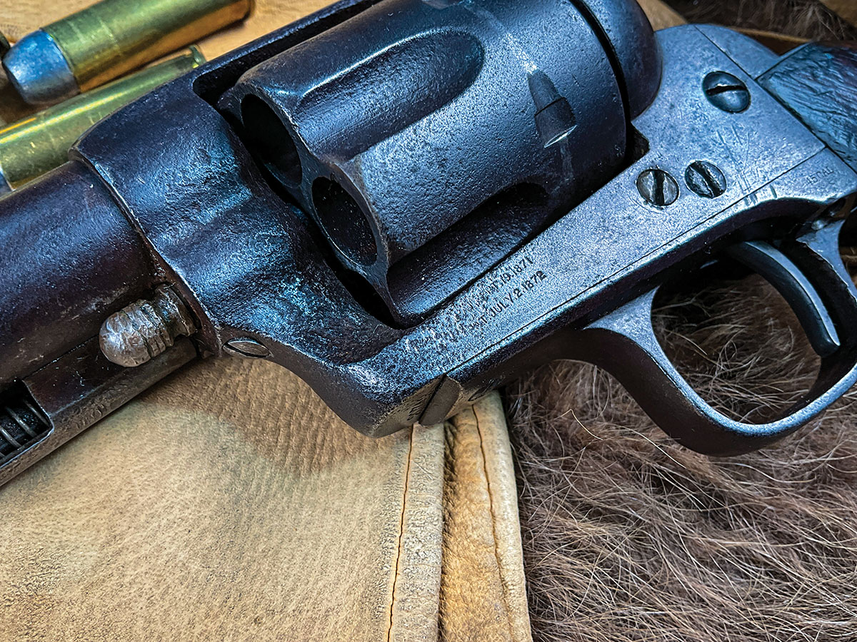 The cylinder pin retaining screw and two-line patent marks indicate an early Colt SAA.